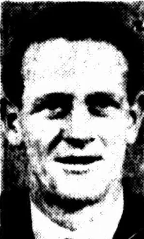 A newspaper portrait of a young man with dark wavy hair, collar and tie, half smiling.